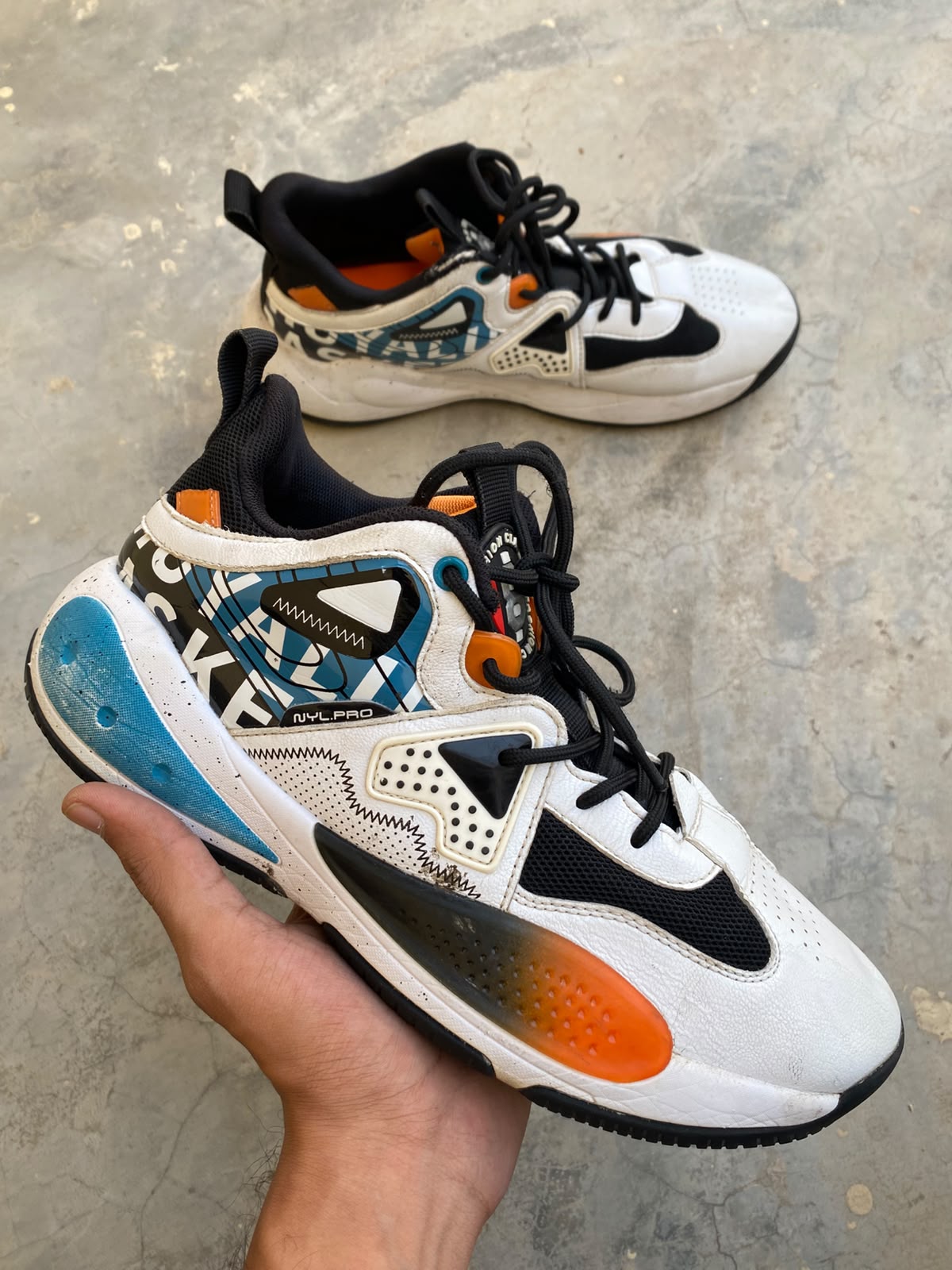 Multi-color high-top athletic sneakers graphic print orange blue panels black laces